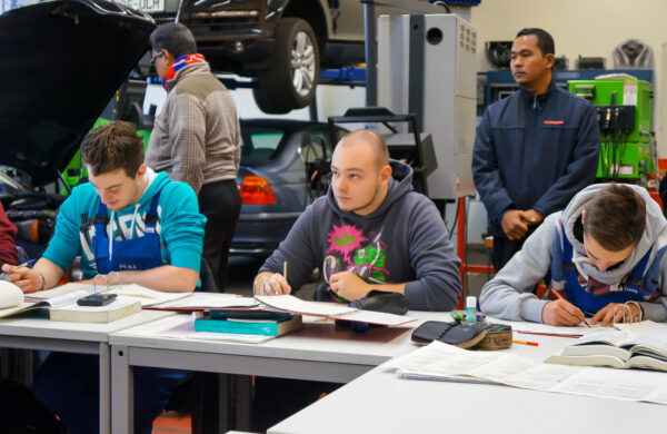 mannen in een lesgroep achter een tafel